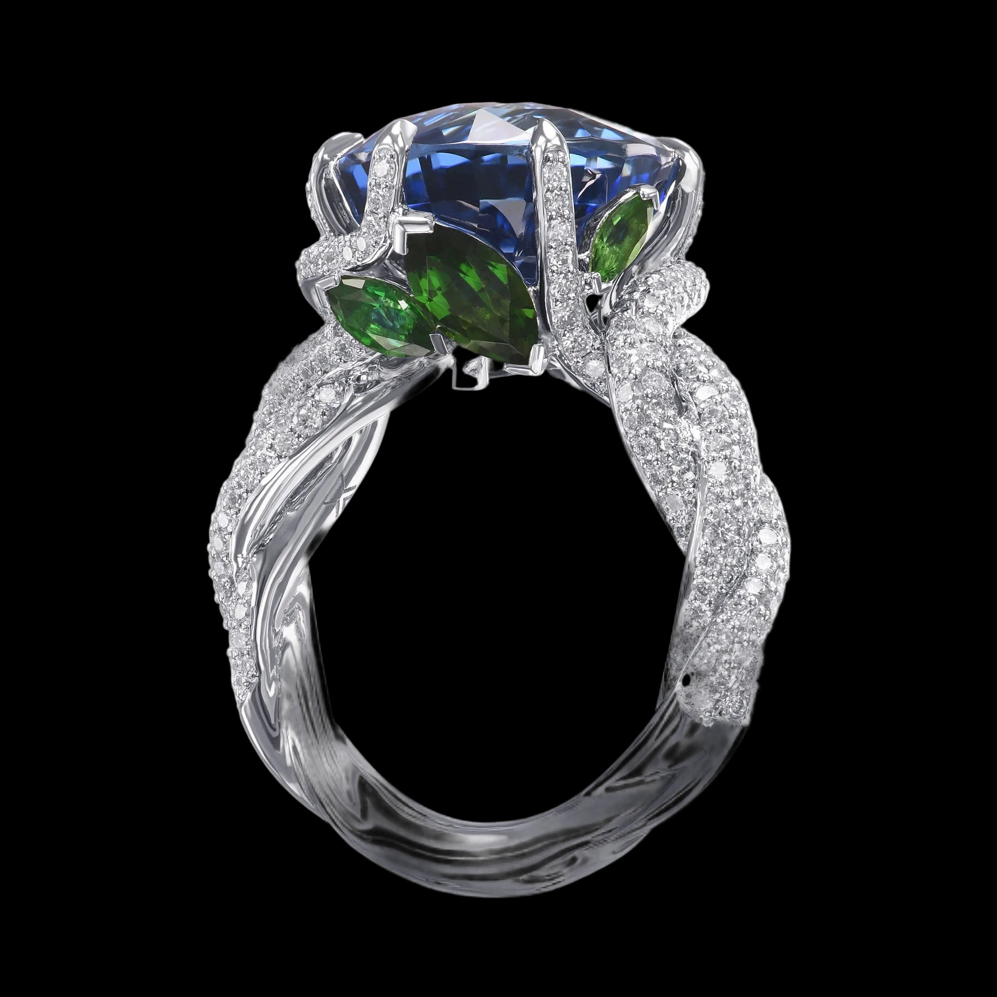 Elegant ring with blue gemstone and green accents on a white background