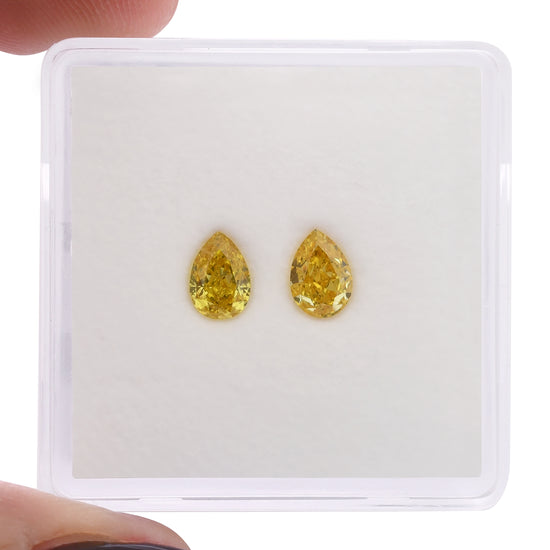 0.64 Carat Fancy Vivid Orangy Yellow Pear Diamonds SI1