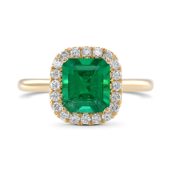 Anello con smeraldo verde vivido e contorno di diamanti