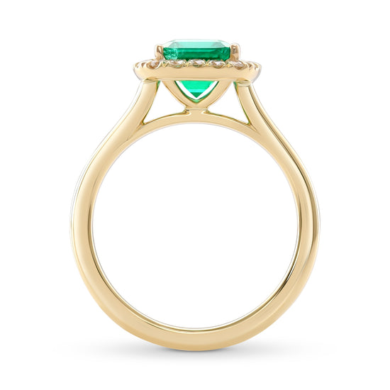 Anello con smeraldo verde vivido e contorno di diamanti