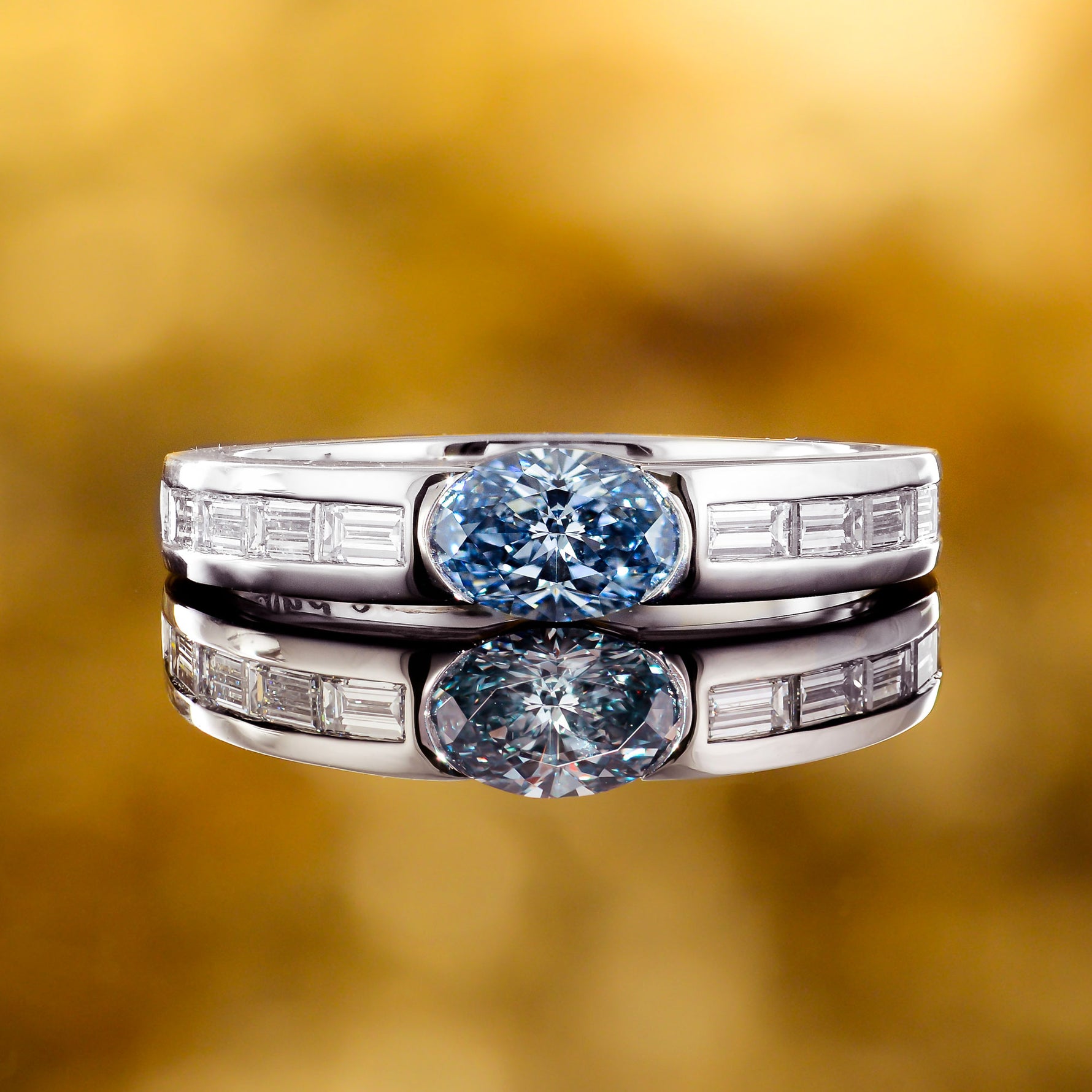 Fancy Intense Blue Oval and Baguette Diamond side stone ring