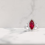 Burmese Marquise Ruby and Heart Diamond Three-Stone Halo Ring