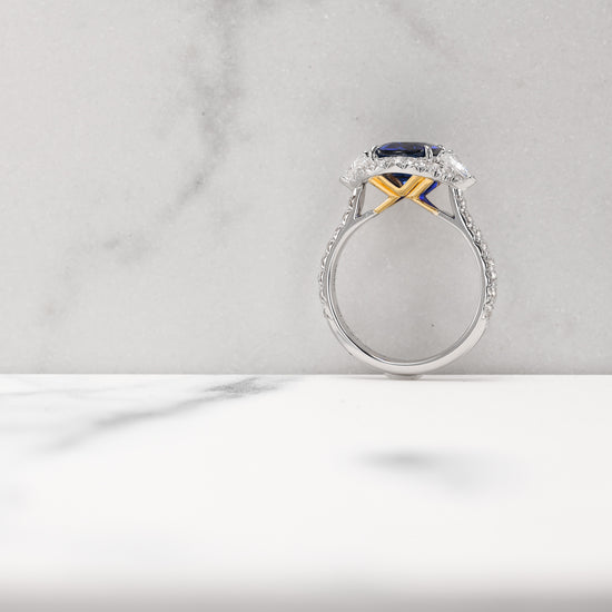 Royal Blue Cushion Sapphire & Triangle Diamond Halo Ring