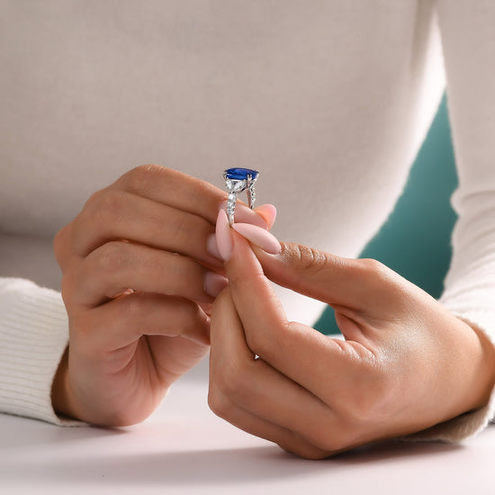 Royal Blue Oval Sapphire and Diamond Side Stone Ring