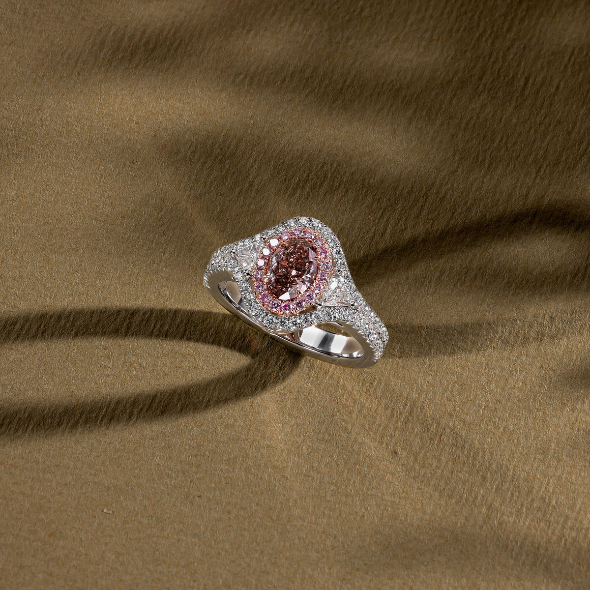 Fancy Pink Brown Oval Three-Stone Halo Diamond Ring