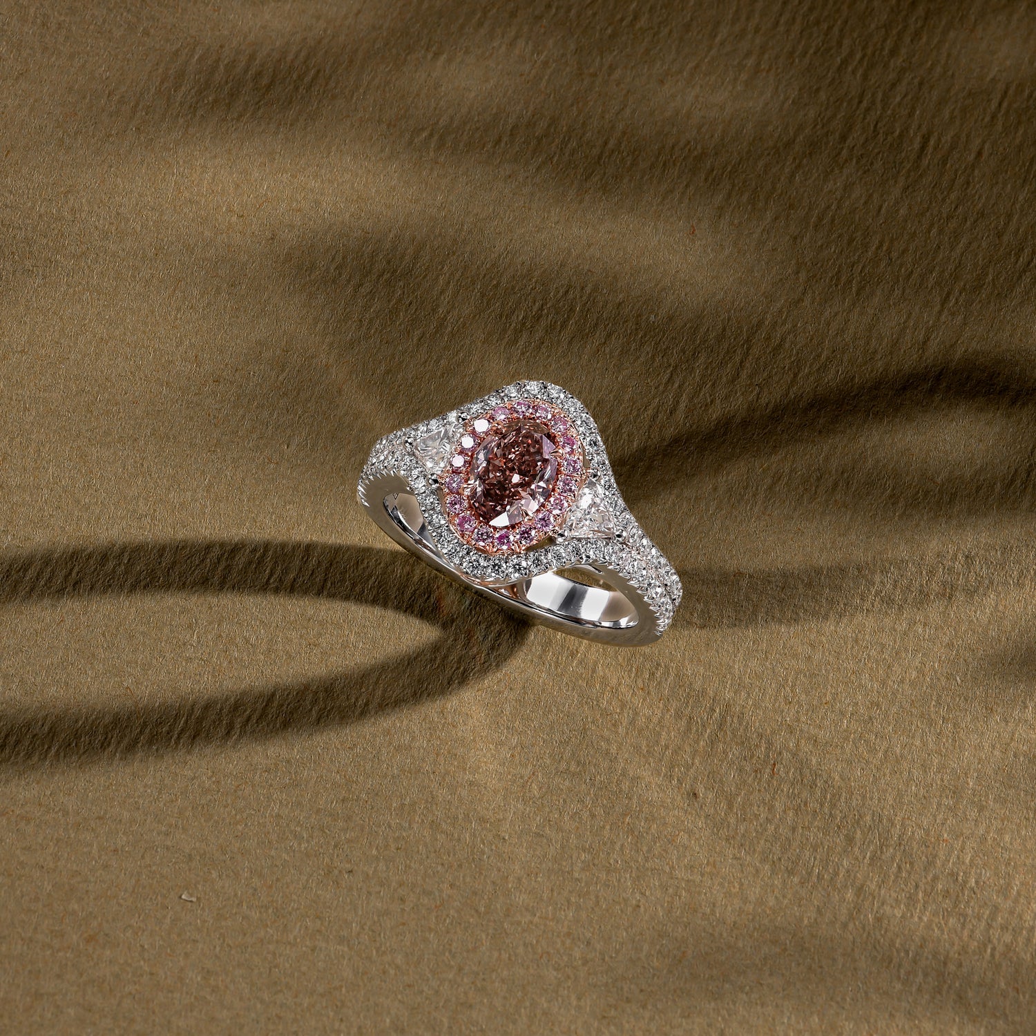 Fancy Pink Brown Oval Three-Stone Halo Diamond Ring